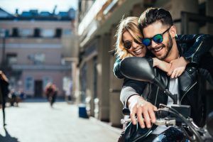 Girl hugging a guy on the motorbike.